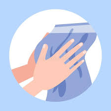 Wiping hands with clean towel after handwashing.
